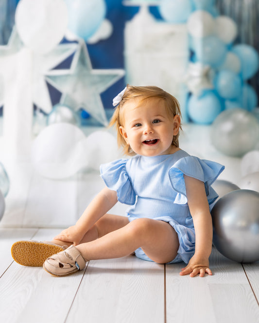 mace and co kids clothing dubai, romper with bow back insky blue colour, linen fabric material, for girls ages infant, toddler up to seven years old, perfect for birthday parties, special occasions and formal wear.